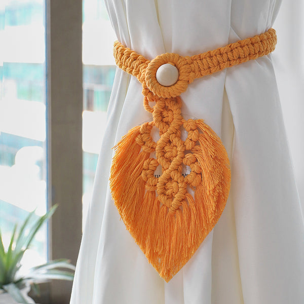 Orange macrame curtain tieback.