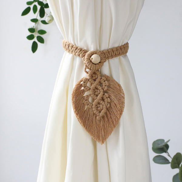 Brown macrame curtain tieback.