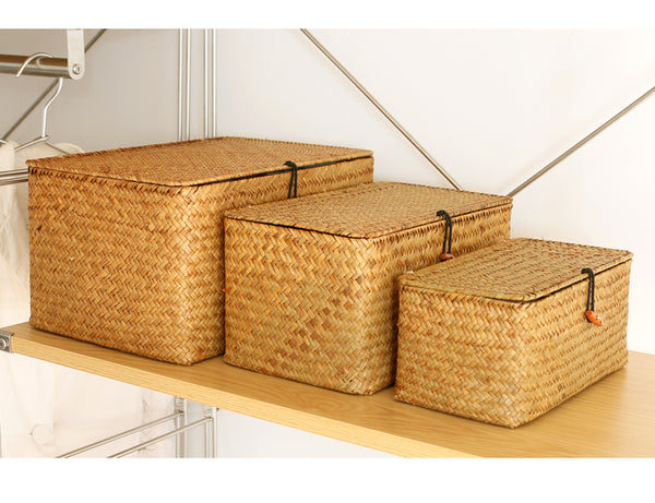 Set of 3 woven seagrass storage chests.